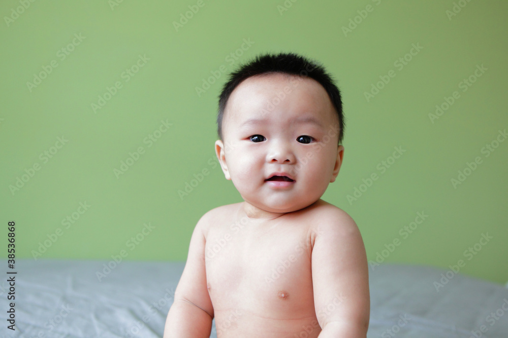 Portrait of smiling baby with green background Portrait of smiling baby with green background