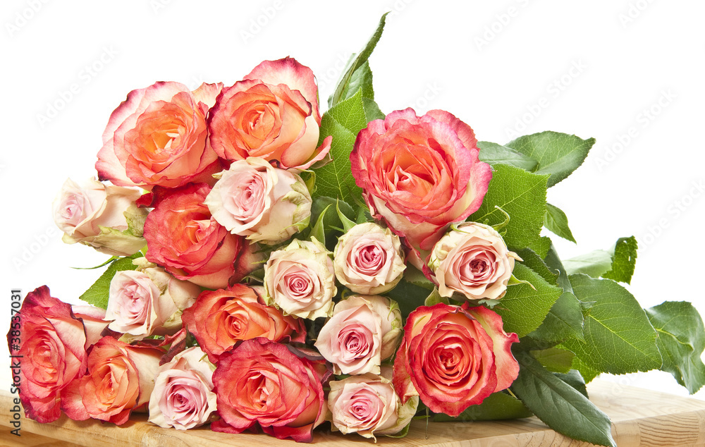 bunch of roses on wooden table