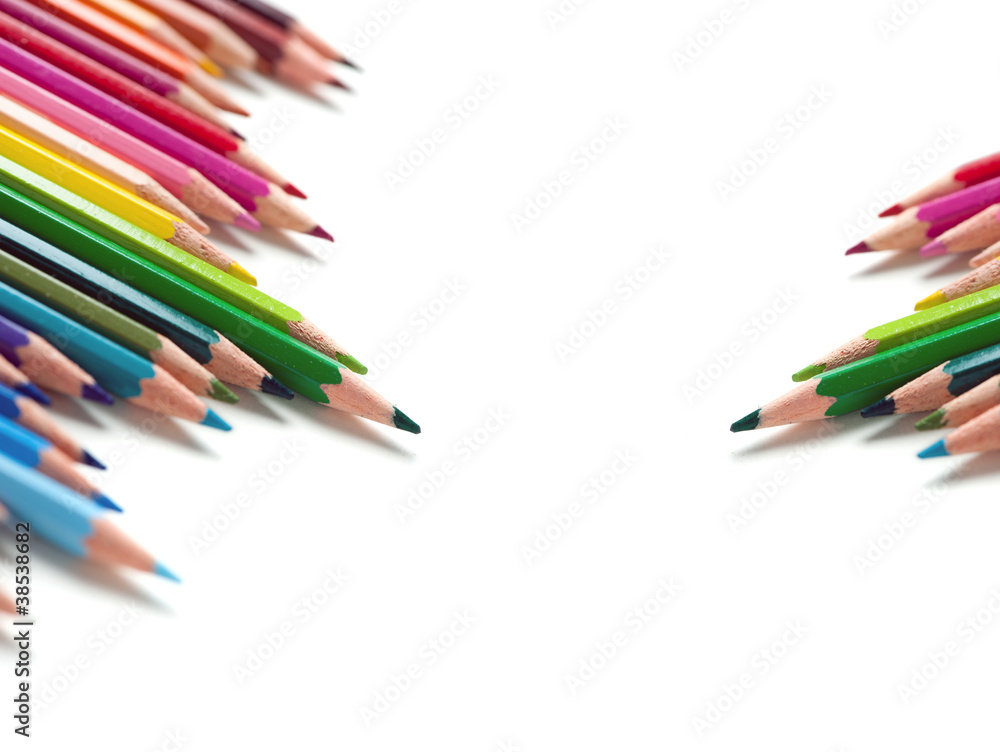 two groups of color pencils on white background