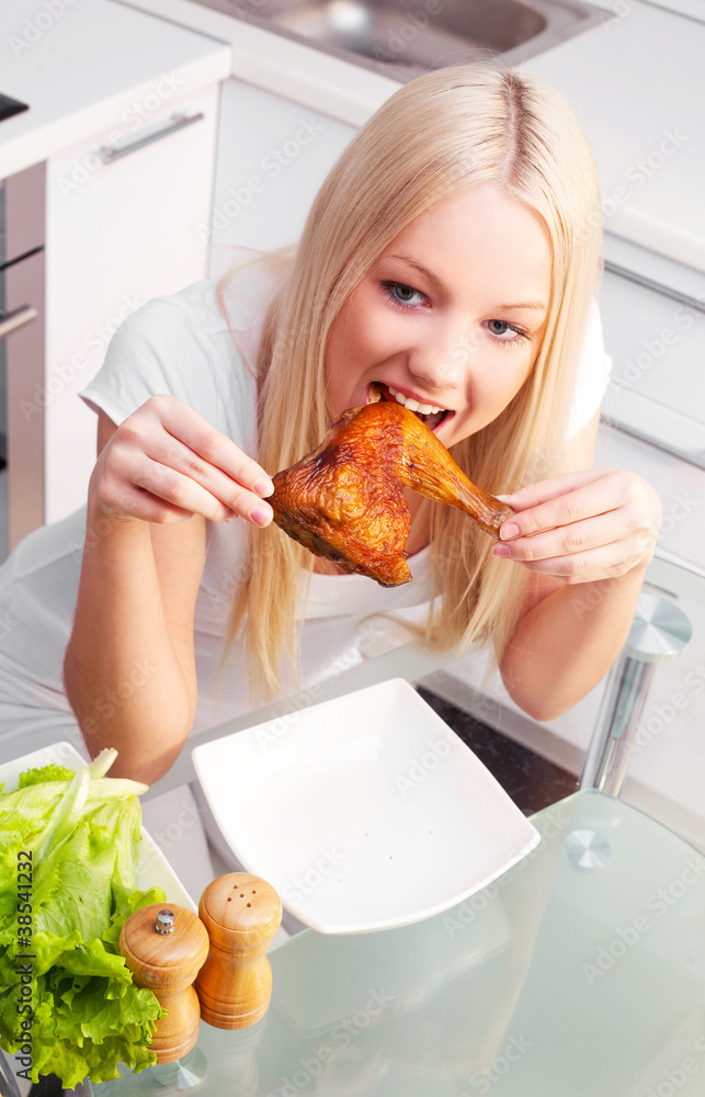 woman eating chicken