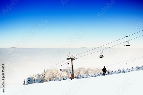 Winter landscape with a ski lift and ski slope