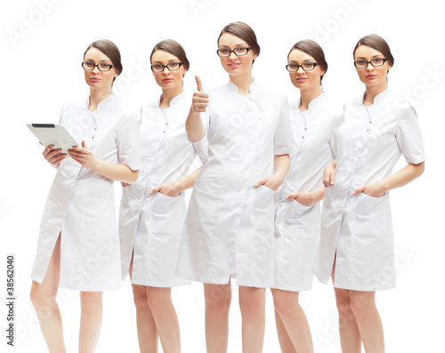 Fotografie Portrait of young pretty doctor thumbs up with her clones in dif