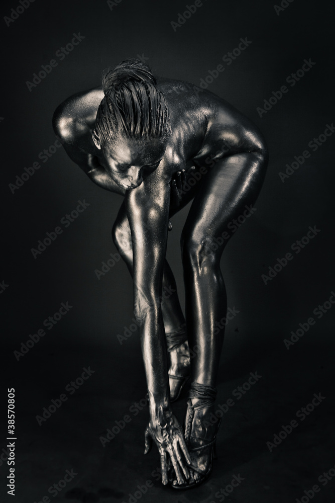 Nude woman like statue in liquid metal
