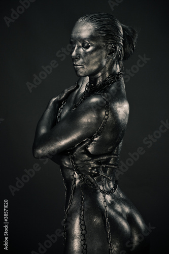 Nude woman like statue in liquid metal