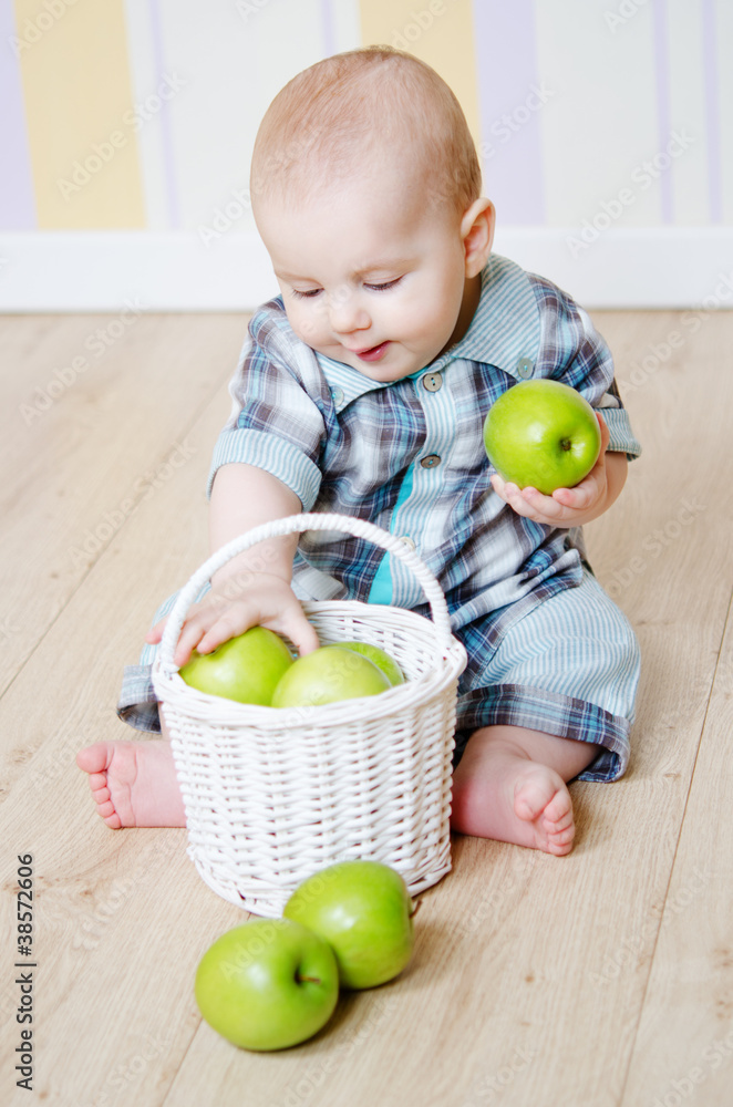 Fototapeta premium little boy with a basket of apples