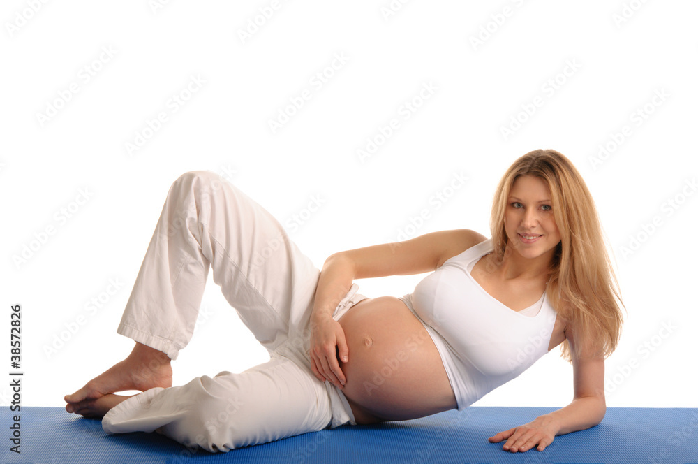 pregnant woman lying down and practicing yoga pregnant woman lying down and practicing yoga