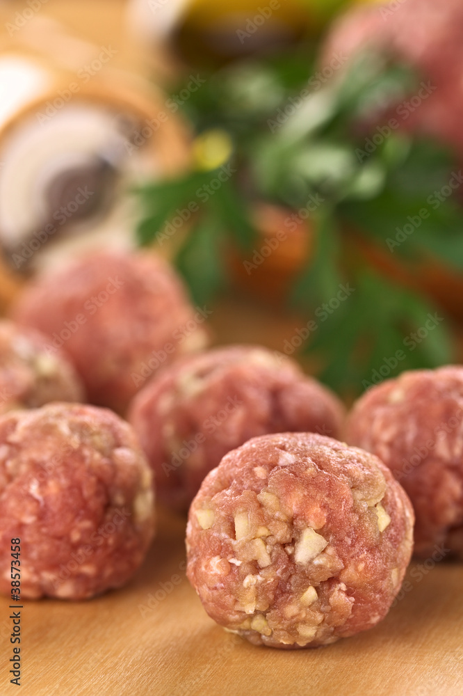 Raw meatballs with garlic (Selective Focus, Focus on the front) Raw meatballs with garlic (Selective Focus, Focus on the front)