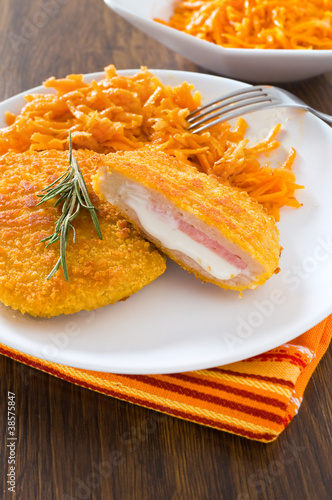 Tableau sur toile Chicken cordon bleu with grated carrots.