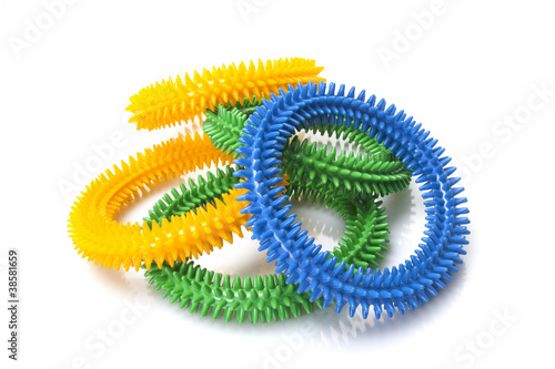 blue, yellow and green massage rings on white background