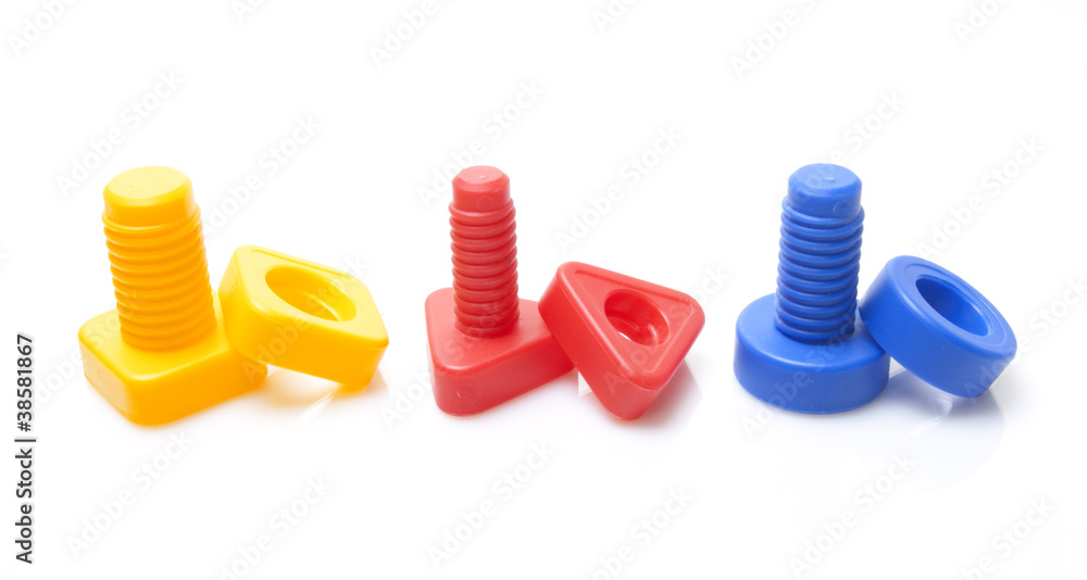 Colourful toy nuts and bolts on white background Colourful toy nuts and bolts on white background