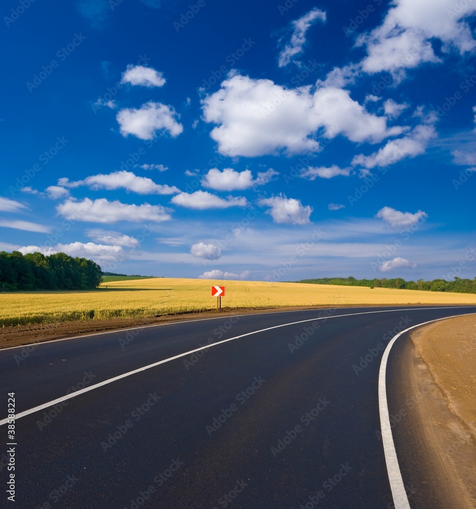Fototapeta premium asphalt road turn amond a fields