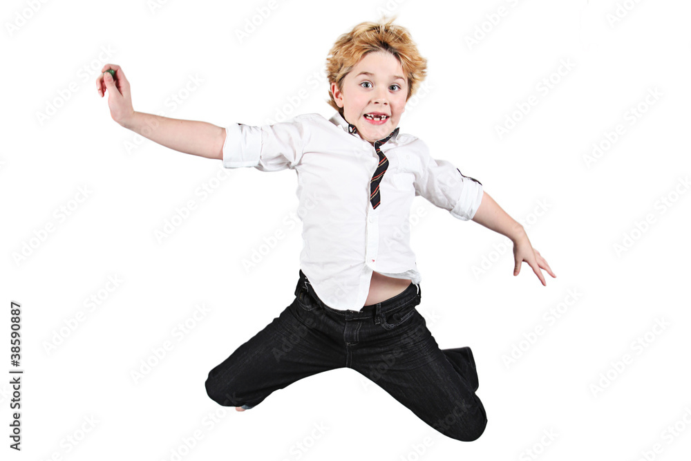 Cute little boy jumping in air on white background