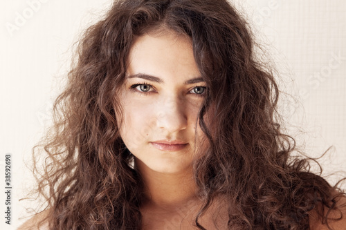 Canvas Print Portrait of a beautiful young brunette with curly hair