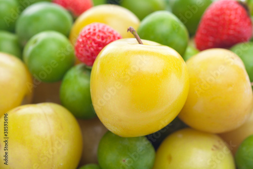 background of strawberry, green and yellow plum