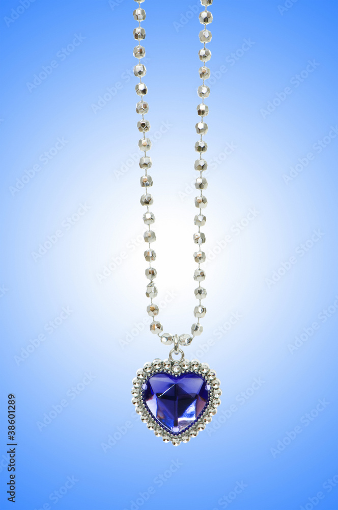 Silver pendant against gradient background Silver pendant against gradient background