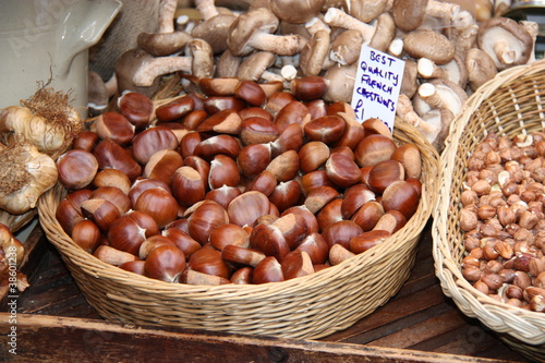A Display Selling French Chestnuts in a Wicker Basket.