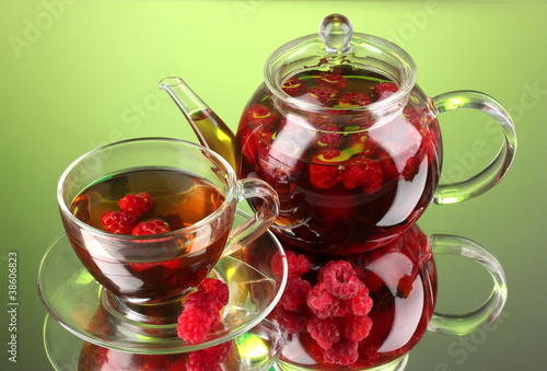 Black fruit raspberry tea in glass teapot and cup