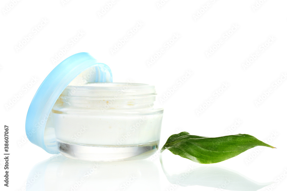 Opened glass jar of cream with fresh green leaf isolated Opened glass jar of cream with fresh green leaf isolated