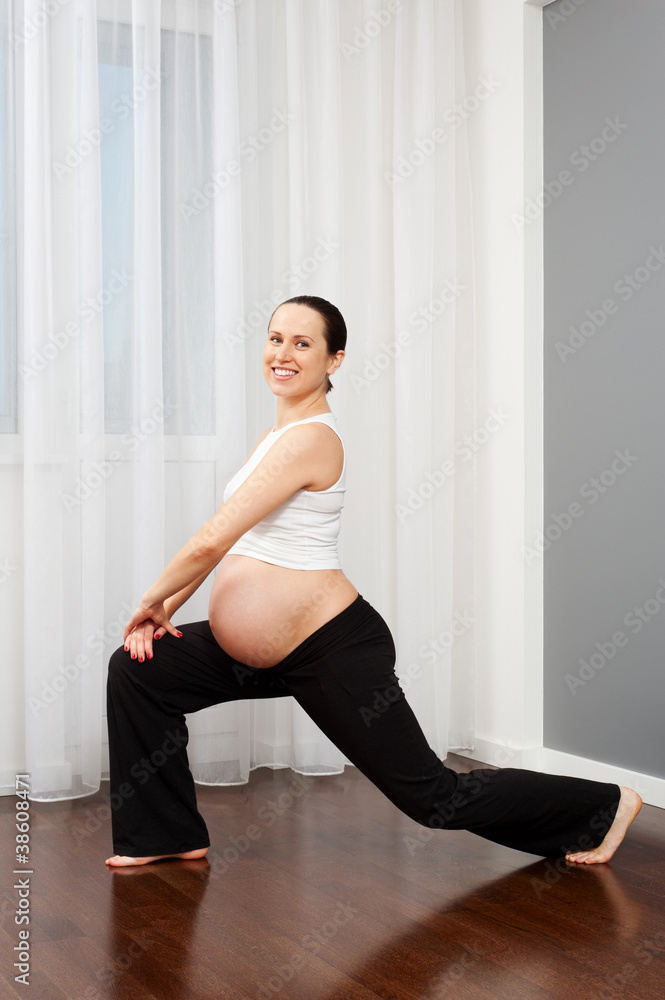 Fototapeta premium pregnant woman doing stretching exercise