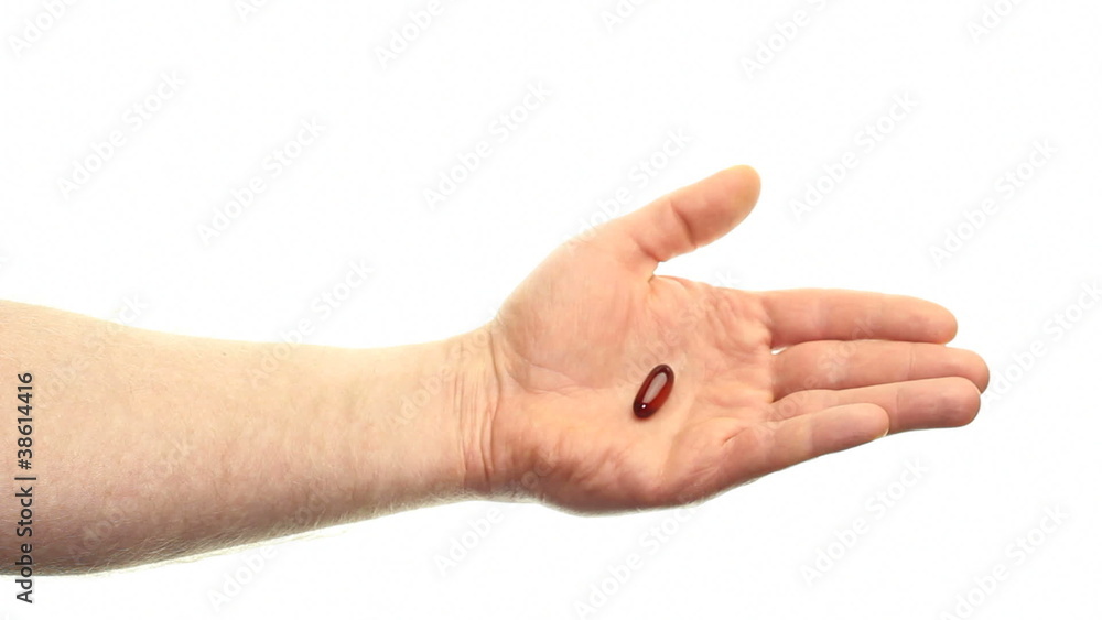 White Hand Showing a Flaxseed Oil Soft Gel Supplement on White White Hand Showing a Flaxseed Oil Soft Gel Supplement on White
