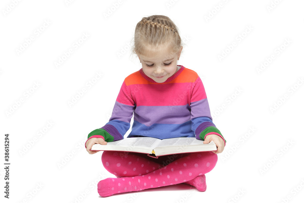 Little girl sitting on the floor reading the book Little girl sitting on the floor reading the book