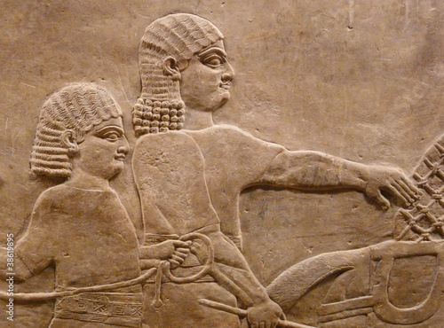 Ancient Assyrian wall carving of men