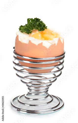 boiled egg in metal stand and parsley isolated on white