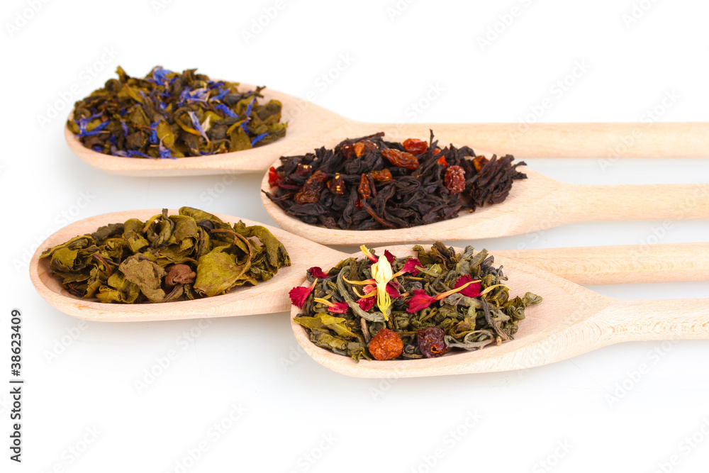 Collection of dry green and black tea in wooden spoons isolated Collection of dry green and black tea in wooden spoons isolated