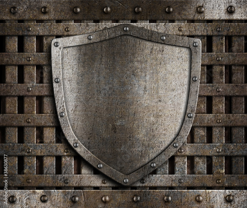 aged metal shield on wooden...