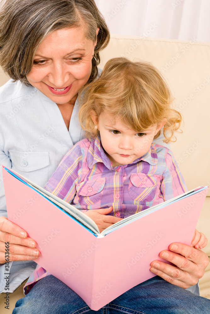 Grandmother and granddaughter read book together Grandmother and granddaughter read book together