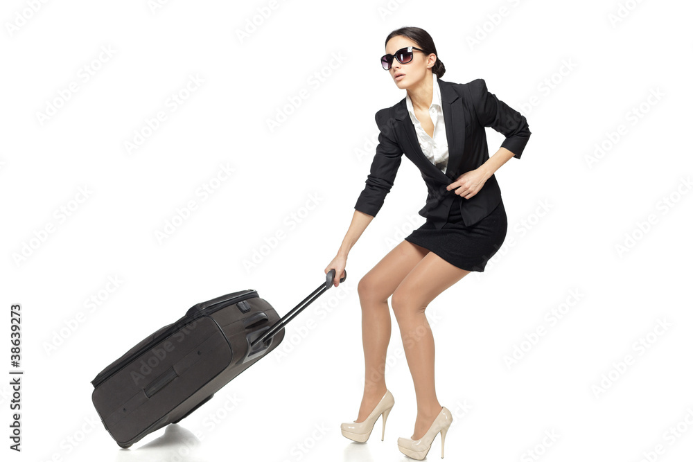 Full length of business woman pulling the heavy travel bag Full length of business woman pulling the heavy travel bag