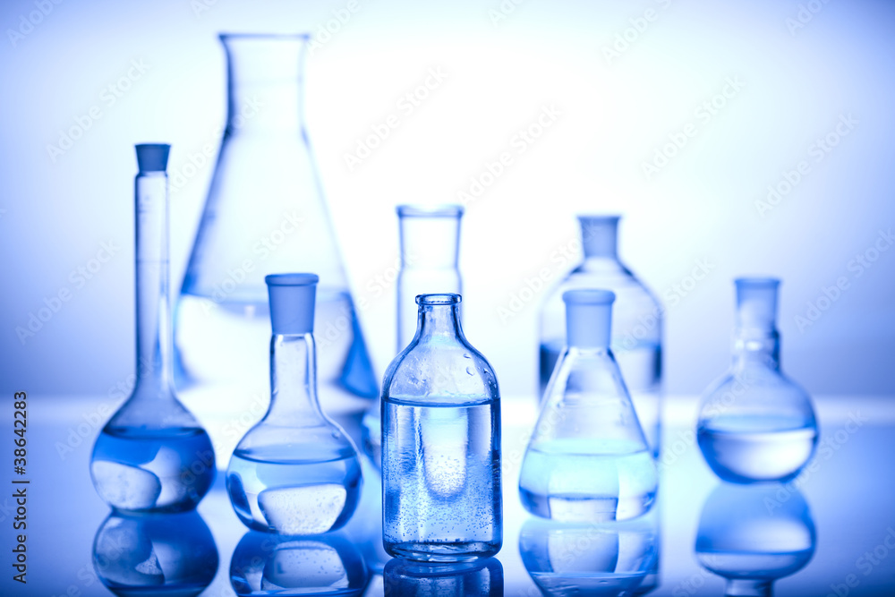 Glass laboratory equipment with blue background Glass laboratory equipment with blue background