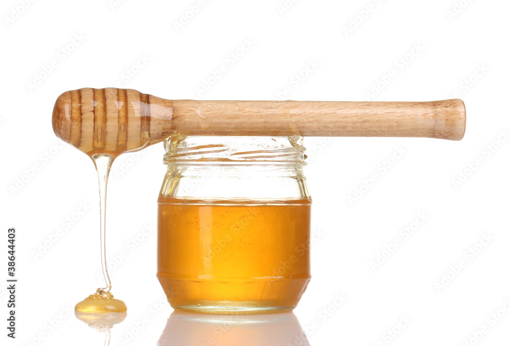 Jar of honey and wooden drizzler isolated on white Jar of honey and wooden drizzler isolated on white