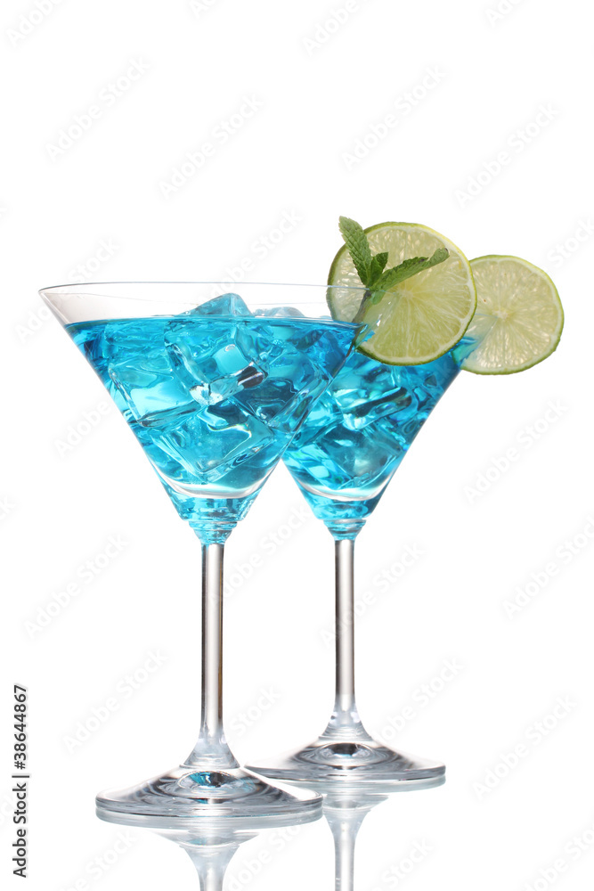 Blue cocktail in martini glasses with ice isolated on white Blue cocktail in martini glasses with ice isolated on white