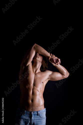 Muscular male body on black background