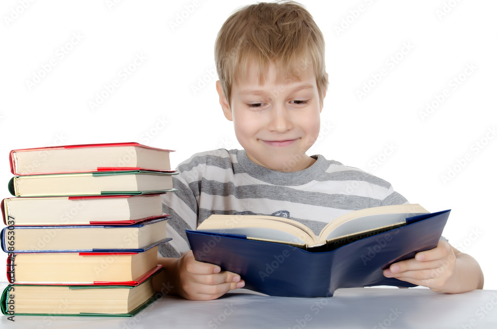 The boy reads the book isolated on white The boy reads the book isolated on white
