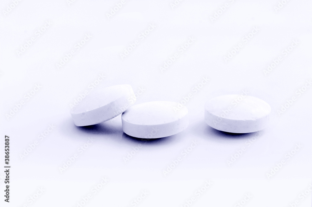 handful of white pills on a lid handful of white pills on a lid