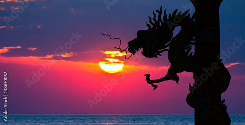 Dragon silhouette and sunset in the sea