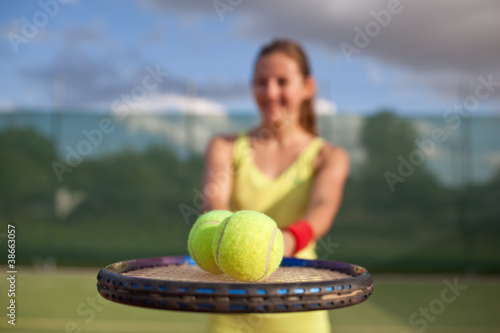 pretty, young female tennis player on the tennis court © lightpoet