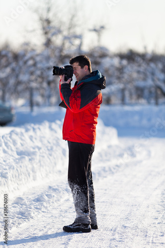 Tourist with camera in the winter
