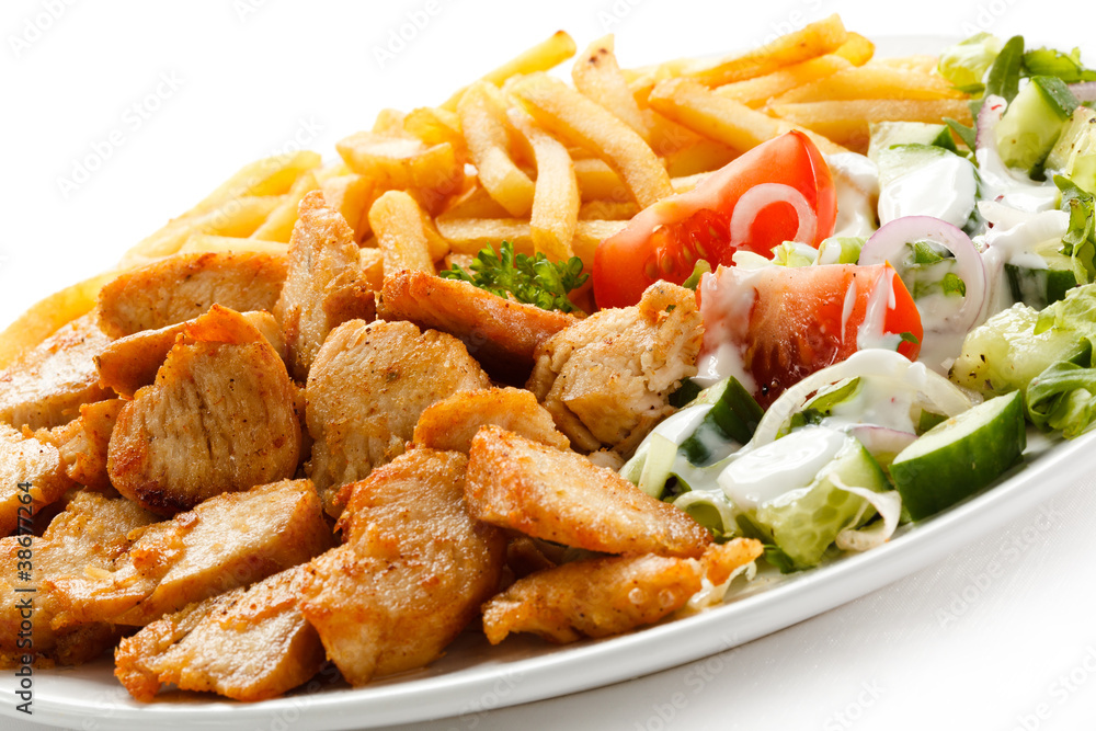Grilled meat with French fries and vegetables Grilled meat with French fries and vegetables