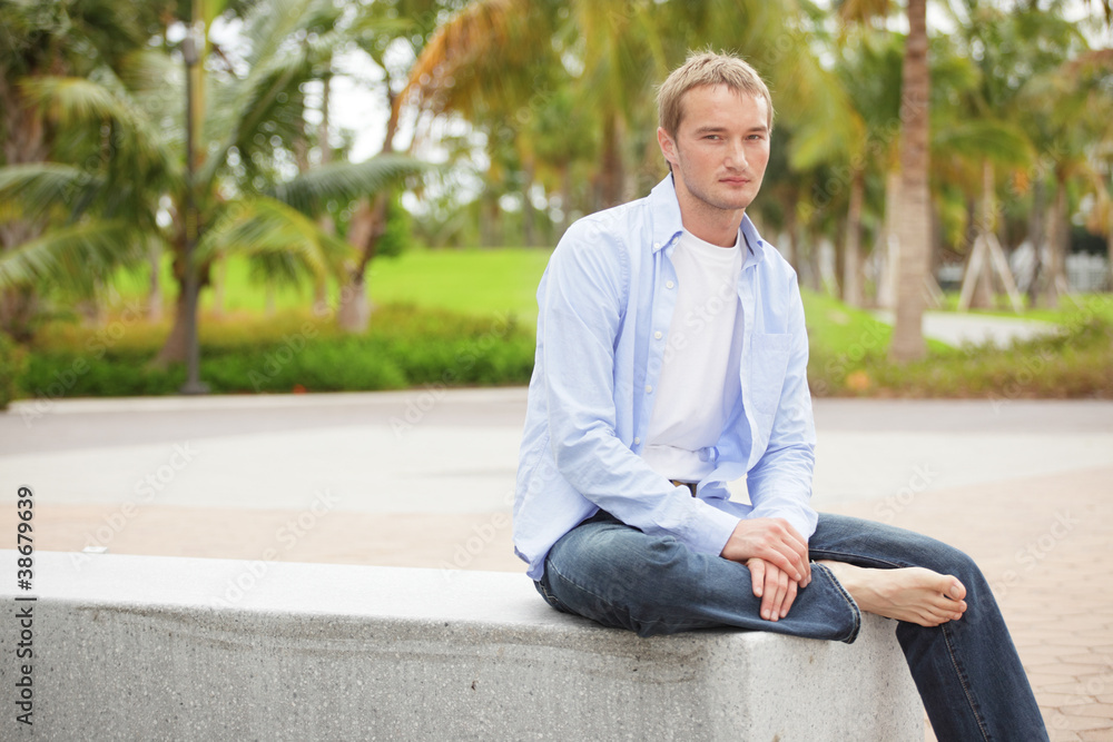 Fototapeta premium Smart casual man sitting in the park