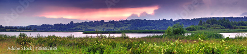 Summer panoramic landscape with river valley at sunset