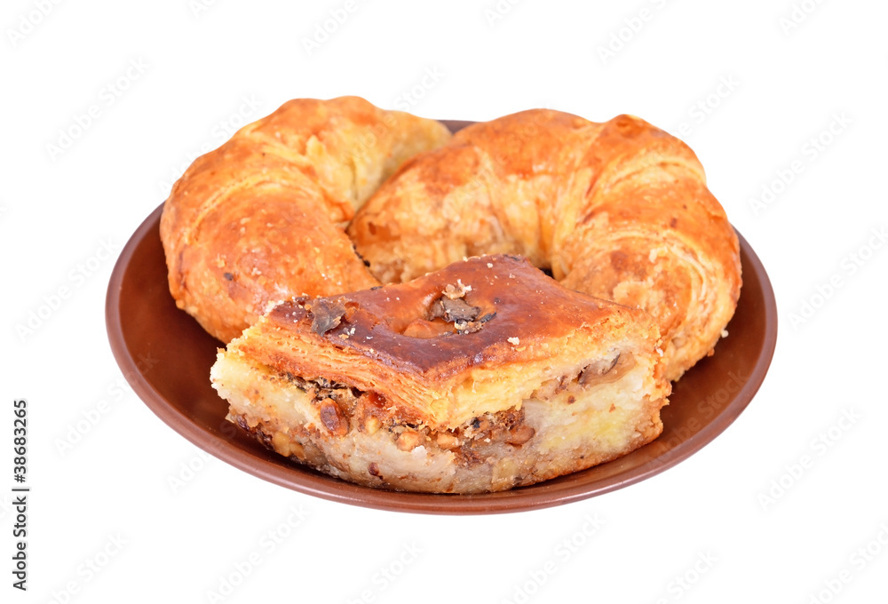 Cookie and crescent roll with nut on plate