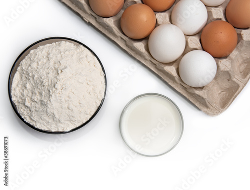 Eggs, glass of milk and flour, isolated