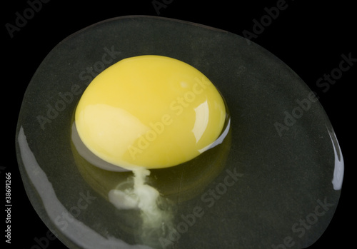 broken egg isolated on black