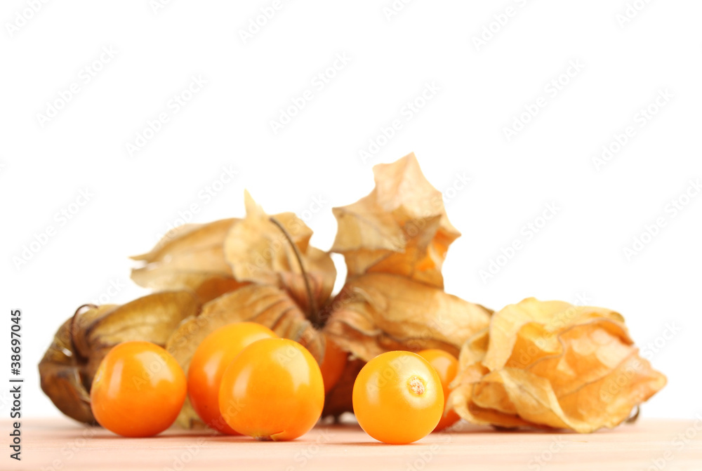 Physalis heap on wooden table on white background Physalis heap on wooden table on white background