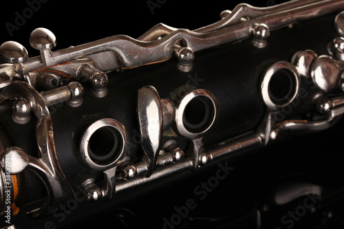 close up detail of clarinet on black background