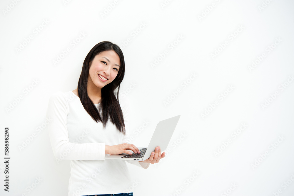 attractive asian woman using laptop in the white room attractive asian woman using laptop in the white room