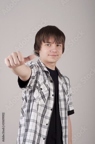 portrait of teen boy, with trumbs up photo